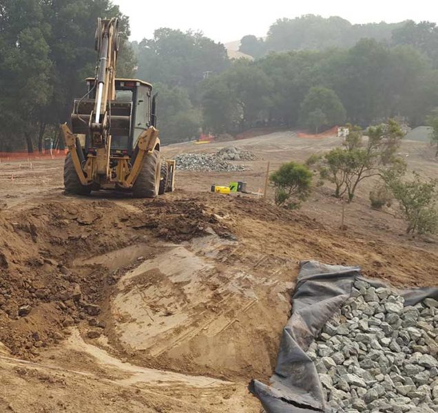 ECI employees grading Bollinger Canyon wetlands project with heay equipment 